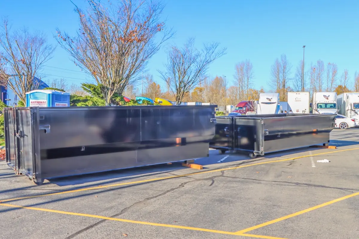 Professional dumpster rental service with roll-off container on residential driveway in Cannon